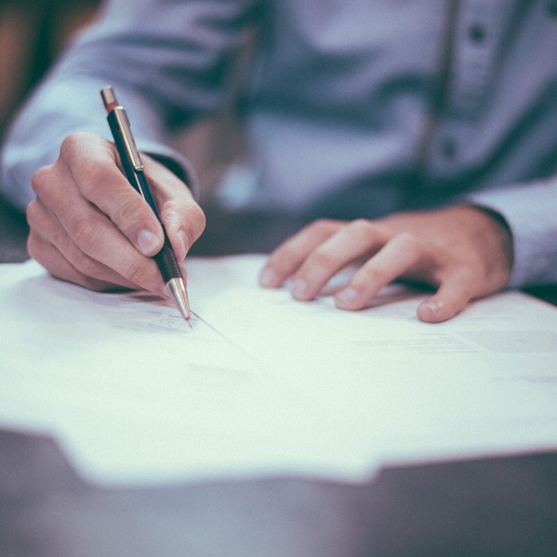 A person signing documents  